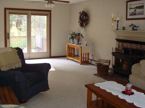 Front to back living room with wood stove.