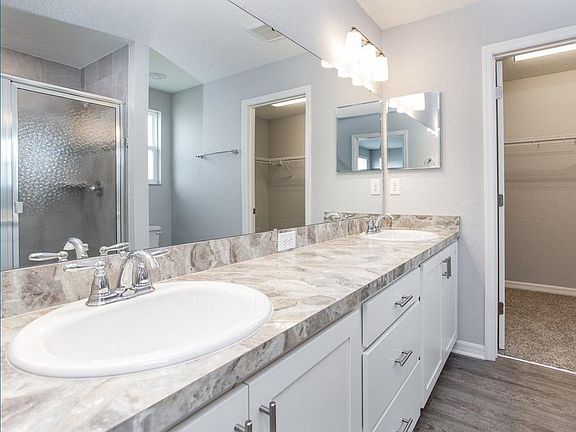 Enjoy having a private en-suite owner s bath with dual vanities and walk-in wardrobe - Wesley home p