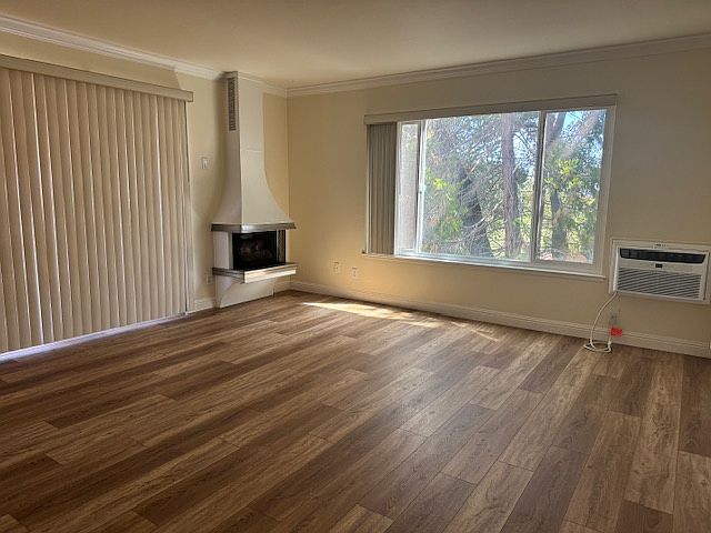 Living room with new luxury vinyl tile, gas fireplace (just flip a switch), AC unit, 8' slider to balcony