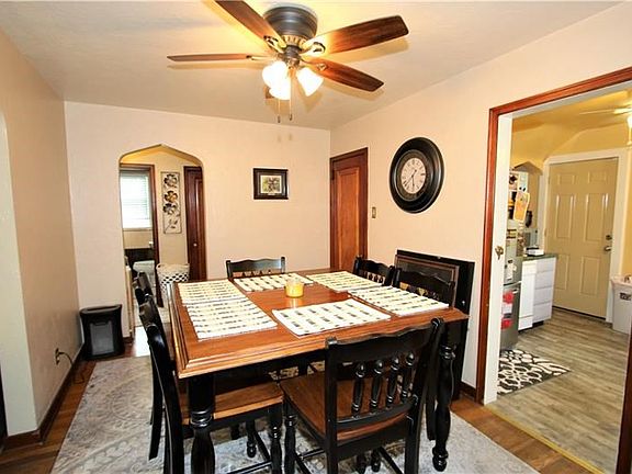 The 13x9 Dining Room connects to the side hall as well as through to the kitchen. Newer Ceiling Fan matches the lovely Hardwood.