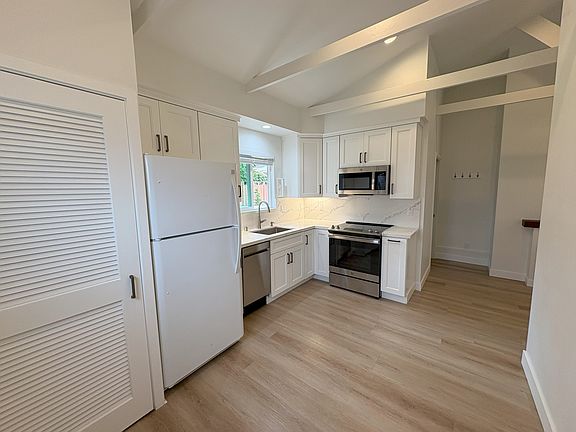 Kitchen and dining room view from entry. Laundry room is on left.