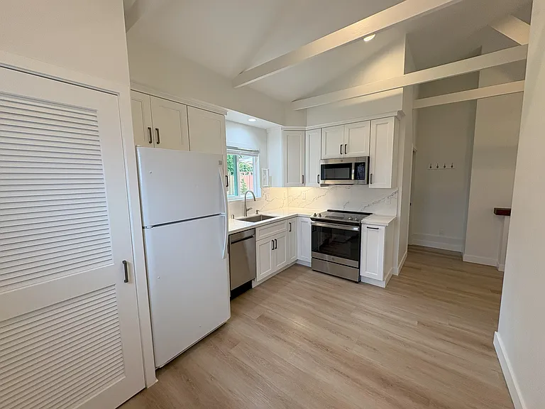 Kitchen and dining room view from entry. Laundry room is on left.