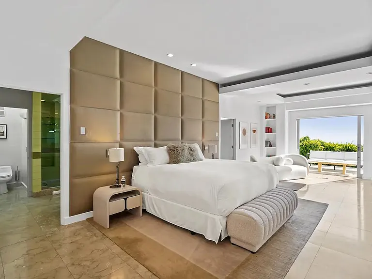 The luxurious primary bedroom features a regal king-size bed for your comfort.