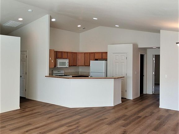 From great room looking into kitchen with hallway to 2 bedrooms and full bath