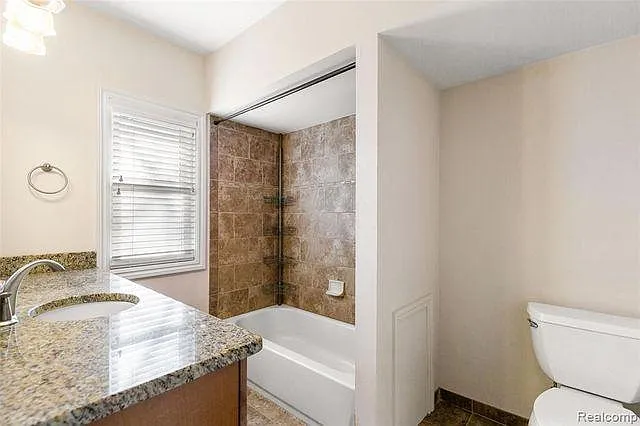 Granite and ceramic tile in full updated bath.