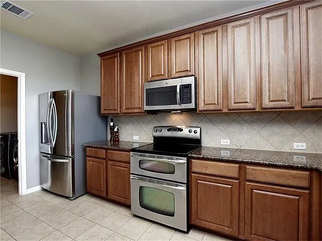 from laundry room into kitchen. The stove in this picture was replaced with a gas stove in 2022. Includes an air-fryer feature