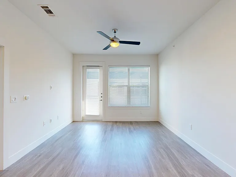 Apartment living room with wood-style flooring.