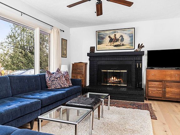 Den and wood burning fireplace view, looking toward front