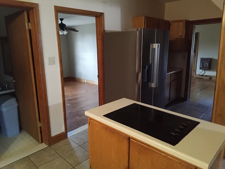 kitchen with new refrigerator and ice maker, cooktop, dishwasher, oven, 
laundry room first door on left, master bedroom second door, living room third door
