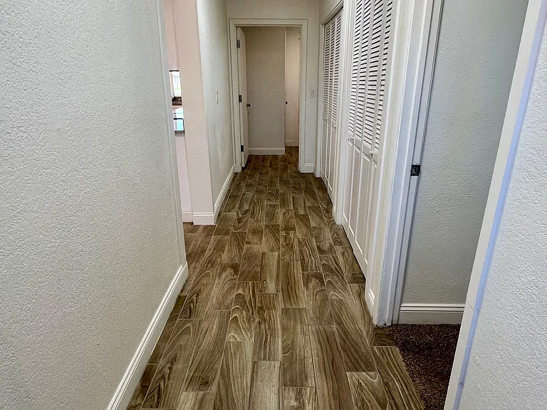 Large hallway leads to master bedroom, pantry and laundry area