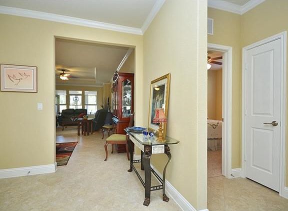 Crown ,molding rims the ceilings of this Sun City Texas Vernon Hill, where off the Foyer are Two Gue