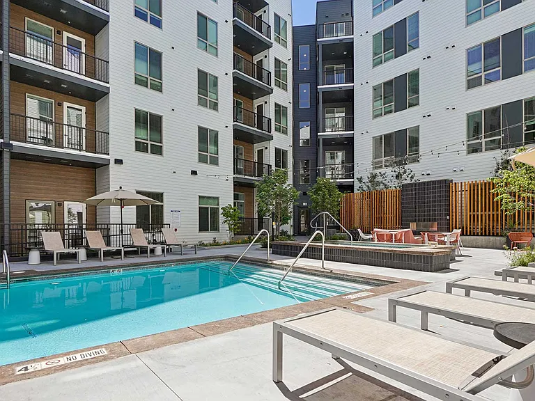 Relax poolside with lounge seating, spa amenities, and inviting outdoor spaces designed for sunny Colorado afternoons.