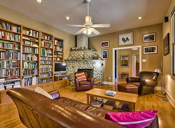 Living room with built ins and river rock fireplace