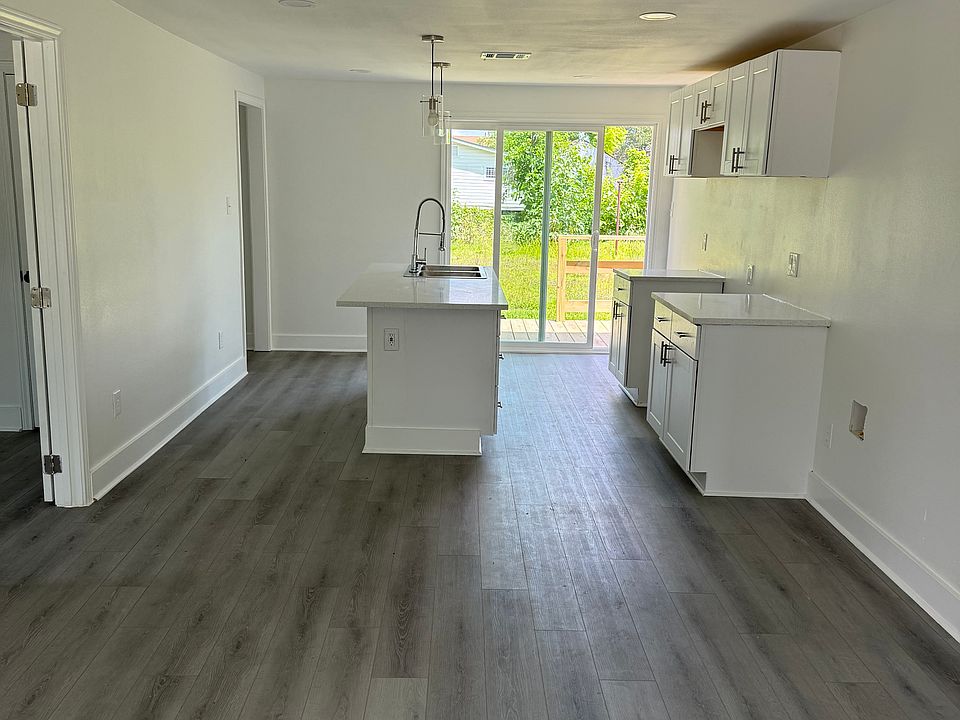 open layout, natural light, recessed lighting, pendant lights at island bar