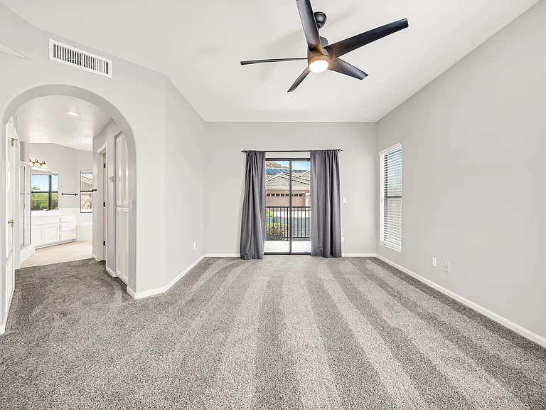 Upstairs master bedroom with a large opening to a huge master bathroom.