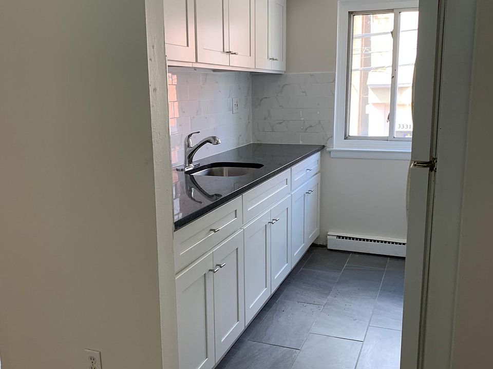 Kitchen featuring granite countertop and shaker style cabinets