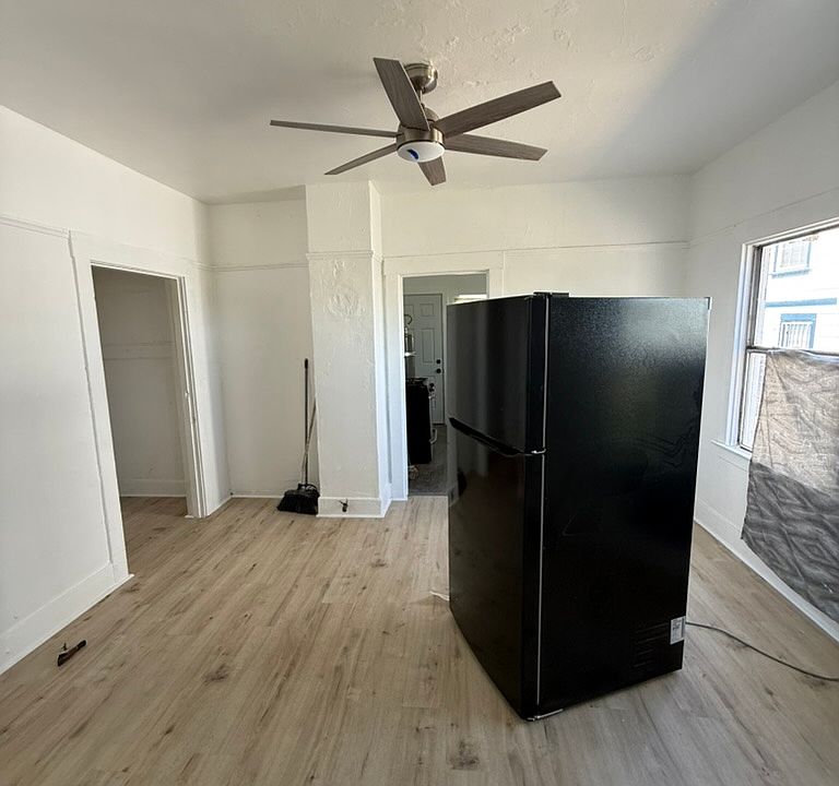 Bedroom with new paint, floors, and fan