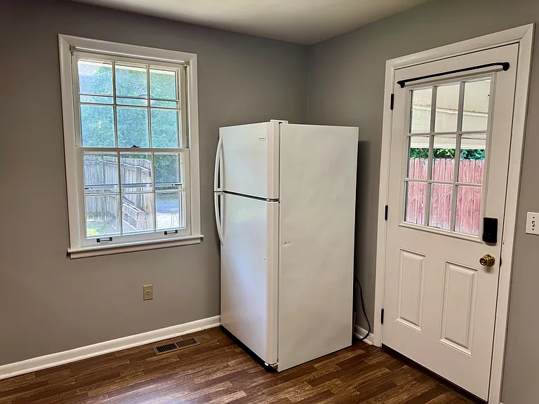 Kitchen entrance through back door in carport.