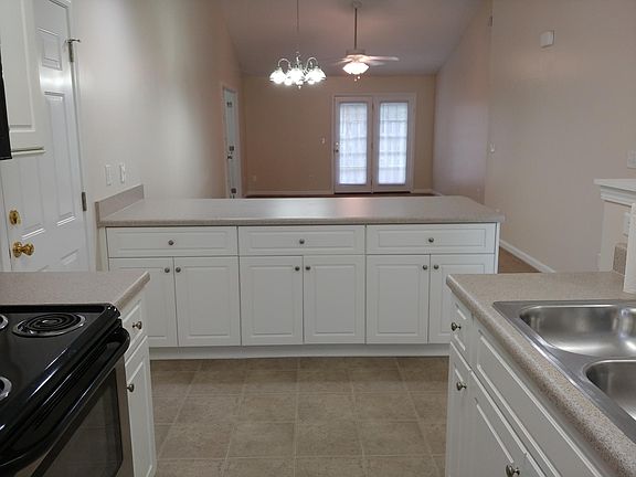 Spacious kitchen cupboards & bar.