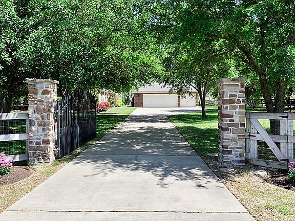 AUTOMATIC WROUGHT IRON   GATE ENTRY W/ STONE COLUMNS WELCOME YOU TO THIS HOME. THE GATE  OPERATING SYSTEM IS NEW. THIS HOME IS COMPLETELY CROSSED FENCED FOR PRIVACY.