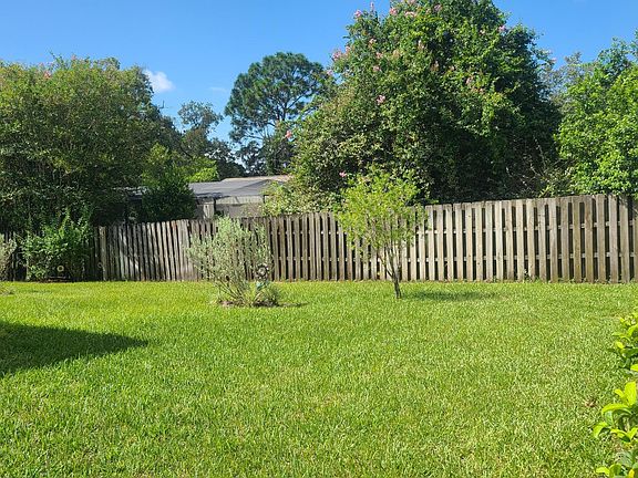 Fully fenced backyard with sprinklers