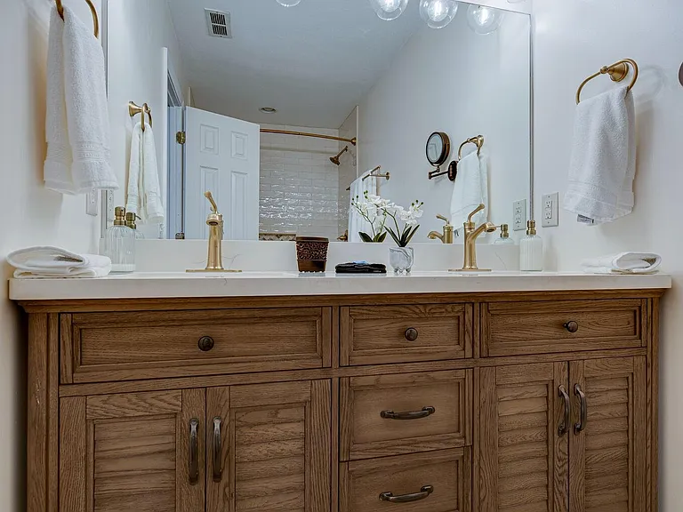 Double sink Master vanity with gorgeous goldtone fixtures and extra outlets