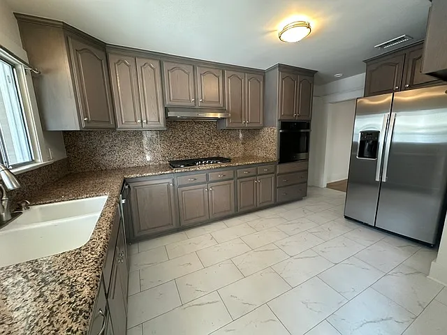 Kitchen with upgraded stainless steel appliances and granite countertops.