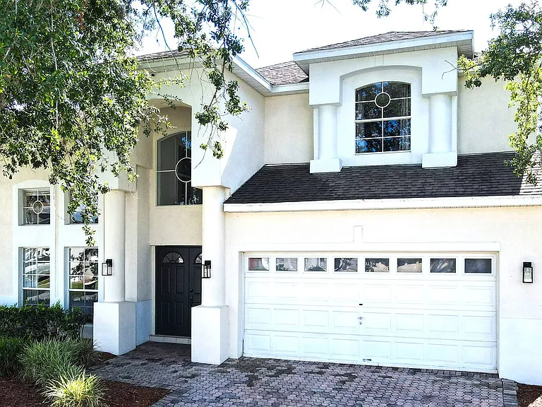 Behold the magnificent exterior of our DisneyEstate! The backyard offers stunning views of your private pool, championship golf course, and resort clubhouse with incredible amenities like Lap Pool, Pickleball, Tennis, and Children's Playground.