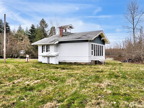 East side of building, small structures are outhouses.>