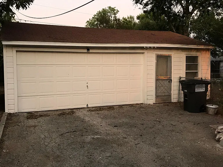 Detached 2 car garage with attached storage room.