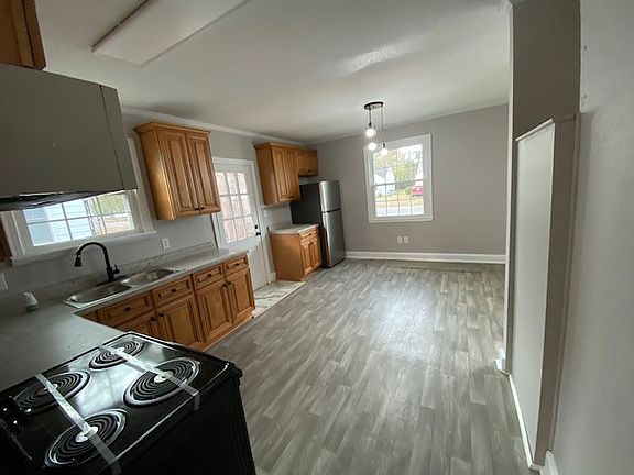 Large eat in kitchen with new cabinets, flooring, appliances, paint, light fixtures, plumbing fixtures, countertop