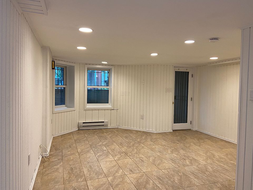 Living room, with front door and windows.