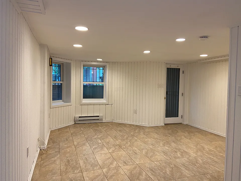 Living room, with front door and windows.