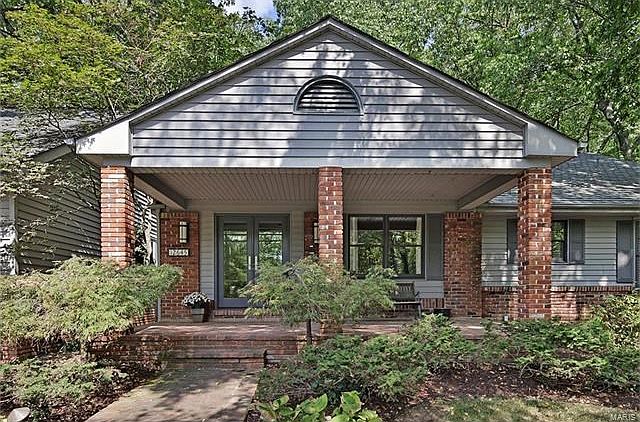 Handsome front elevation has a lovely landscaped yard and circular driveway.
