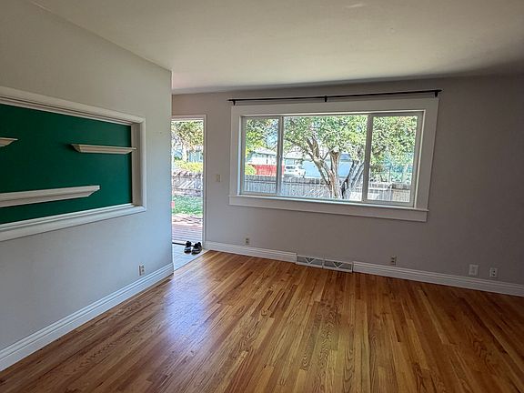 Natural light and original hardwood floors in living room