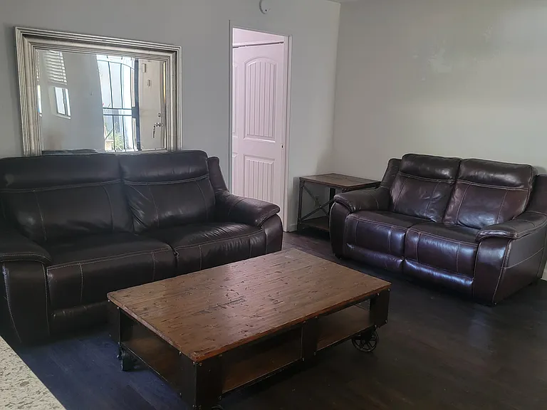 Spacious, open living room (photos reflect a furnished layout for reference; the room is unfurnished).