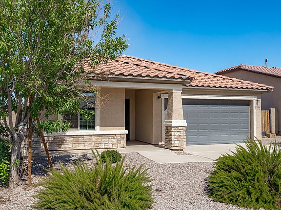 Tile roof, stone accent design, xeriscape landscaping for minimal maintenance.