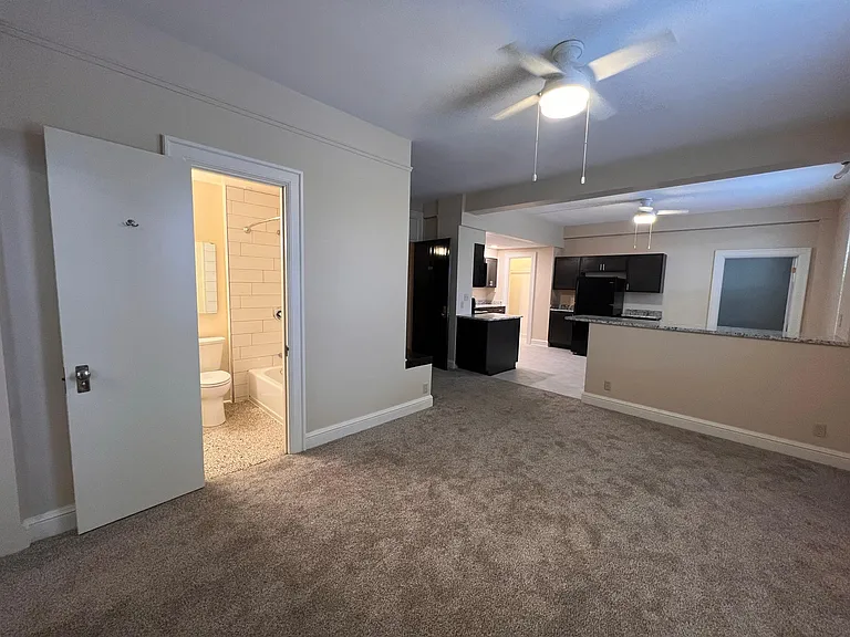 Living room with bathroom w/tub shower combo