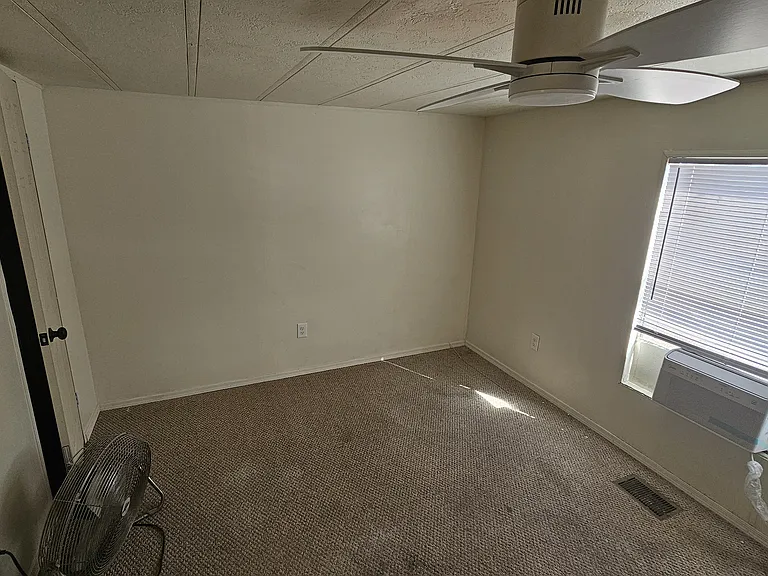 The photo shows the previous flooring before upgrades; the home now features freshly installed LVP that gives the space a clean, modern feel.