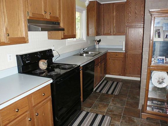 The Kitchen offers Wood Cabinets, newer flooring & updated appliances