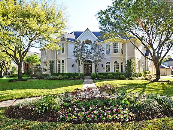 THIS ELEGANT CUSTOM STUCCO  IS MAJESTICALLY PLACED ON THIS GORGEOUS CORNER LOT!