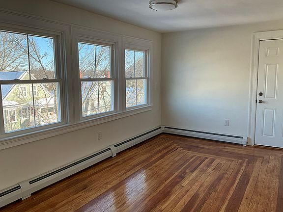 Front door from living room with large windows with views on the left.
