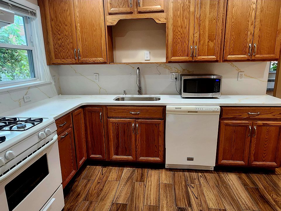 Large kitchen with new appliances, floor and countertops.