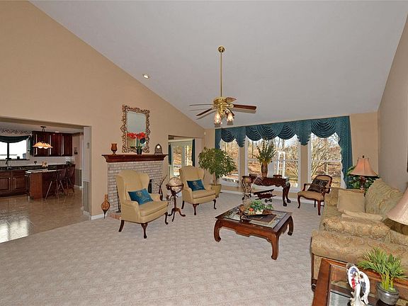 This  wall of windows enhances a beautiful view and the See through fireplace offers a warm glow.  Add to that a vaulted ceiling that makes this spacious great room light and bright.