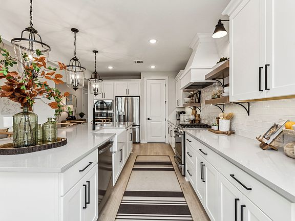 Gorgeous cabinets and pendant lighting illuminate your kitchen