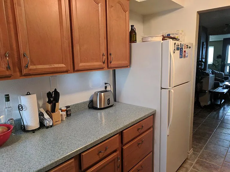 More cabinets, countertop, drawers, fridge.