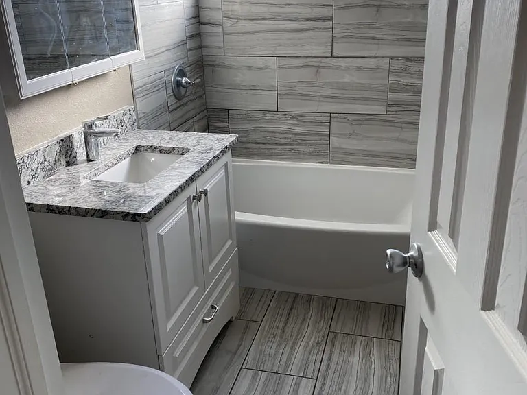 Remodeled bathroom with tub, shower