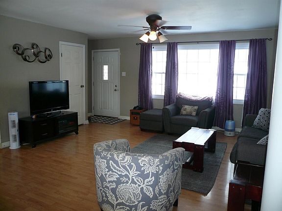 View of front entryway in spacious living room.