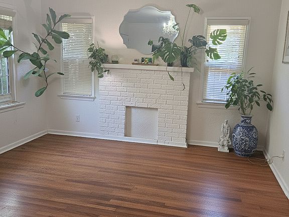 Large, filled with light and windows, includes chandellier, wood floors and flow through to the dining room