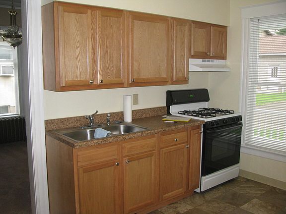 Large kitchen equipped with stove and refrigerator.